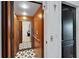 Modern elevator with patterned tile flooring and wooden interior provides easy access between floors at 6412 Mayra Shores Ln, Apollo Beach, FL 33572