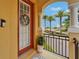 Charming entryway features an arched doorway with pillars and beautiful tropical landscaping at 6412 Mayra Shores Ln, Apollo Beach, FL 33572