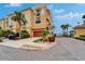 The beautiful yellow exterior of this townhouse features lush tropical landscaping at 6412 Mayra Shores Ln, Apollo Beach, FL 33572