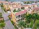 Three-story townhome with multiple balconies showcasing a charming, well-maintained facade and lush landscaping at 6412 Mayra Shores Ln, Apollo Beach, FL 33572
