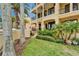 Stunning building exterior featuring balconies, lush landscaping, and elegant architectural details at 6412 Mayra Shores Ln, Apollo Beach, FL 33572