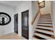 Hallway with staircase and stylish doors leads to other parts of the home at 6412 Mayra Shores Ln, Apollo Beach, FL 33572