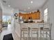 Open kitchen with stainless steel appliances, a breakfast bar, and views of the water at 6412 Mayra Shores Ln, Apollo Beach, FL 33572