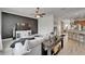 Open-concept living room with stylish furnishings, a large TV, and a modern accent wall at 6412 Mayra Shores Ln, Apollo Beach, FL 33572