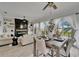 Open-concept living space with elegant dining table, comfy seating and a view of the water at 6412 Mayra Shores Ln, Apollo Beach, FL 33572