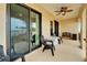Relaxing covered porch with patio furniture, ceiling fan, and sliding glass doors overlooking the view at 6412 Mayra Shores Ln, Apollo Beach, FL 33572