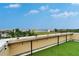 Roof deck with artificial grass and views of the bay framed by lush tropical landscaping at 6412 Mayra Shores Ln, Apollo Beach, FL 33572