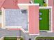 Aerial view of the rooftop showing a lounge area with artificial turf, a patio, and the red tile roof at 6412 Mayra Shores Ln, Apollo Beach, FL 33572