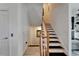 Staircase featuring carpeted stairs, white risers, and a beautiful wooden handrail at 6412 Mayra Shores Ln, Apollo Beach, FL 33572