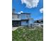 Backyard view of the two-story townhouse showing the patio, lawn, and AC Unit at 6620 121St Ave # 1, Largo, FL 33773