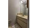 Compact bathroom featuring a single sink vanity and a framed mirror at 6620 121St Ave # 1, Largo, FL 33773