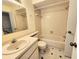 Bathroom featuring a single vanity, a bathtub, and tile walls at 6620 121St Ave # 1, Largo, FL 33773