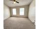 Bedroom featuring neutral carpet flooring, and two windows offering natural light at 6620 121St Ave # 1, Largo, FL 33773