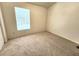 A bright bedroom featuring carpet and a window with blinds at 6620 121St Ave # 1, Largo, FL 33773