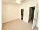 Bright bedroom with carpet and door to bathroom and hall at 6620 121St Ave # 1, Largo, FL 33773