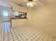 Dining room featuring tile flooring, kitchen bar, ceiling fan, and lots of light at 6620 121St Ave # 1, Largo, FL 33773