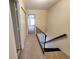 Upstairs hallway with carpet leading to bedrooms and featuring a dark handrail at 6620 121St Ave # 1, Largo, FL 33773
