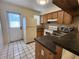 Functional kitchen featuring a breakfast bar, ample counter space and tiled floor at 6620 121St Ave # 1, Largo, FL 33773