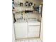 Laundry room featuring a white washer and dryer with shelving above at 6620 121St Ave # 1, Largo, FL 33773