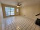 Inviting living room with tile flooring, ceiling fan, and natural light at 6620 121St Ave # 1, Largo, FL 33773