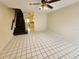 Open-concept living room features tile flooring, stairs, and lots of natural light at 6620 121St Ave # 1, Largo, FL 33773
