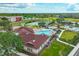 Aerial shot displays a community pool, clubhouse, and playground, complemented by lush landscaping at 6914 Monarch Park Dr, Apollo Beach, FL 33572