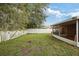 Large grassy backyard featuring a well-maintained lawn and a white fence at 6914 Monarch Park Dr, Apollo Beach, FL 33572