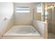 Bright bathroom featuring a soaking tub and glass shower at 6914 Monarch Park Dr, Apollo Beach, FL 33572