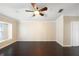 Neutral bedroom featuring a ceiling fan, crown molding, and hardwood floors at 6914 Monarch Park Dr, Apollo Beach, FL 33572