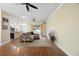 Open living room with hardwood floors and neutral paint, complemented by natural light and a ceiling fan at 6914 Monarch Park Dr, Apollo Beach, FL 33572
