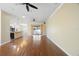 Bright living room with hardwood floors and natural light, with an open layout adjacent to kitchen and dining areas at 6914 Monarch Park Dr, Apollo Beach, FL 33572