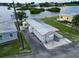 Aerial view of a single-story home with metal roof, a storage shed, and waterfront access at 800 Chesapeake Dr # 23, Tarpon Springs, FL 34689