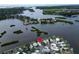 Panoramic aerial view of single-story homes near a beautiful river and lush greenery at 800 Chesapeake Dr # 23, Tarpon Springs, FL 34689