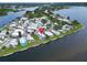 Picturesque aerial view of waterfront homes with boat docks and lush landscaping in a tranquil community at 800 Chesapeake Dr # 23, Tarpon Springs, FL 34689