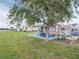 Spacious backyard with a patio area and lush lawn, perfect for outdoor gatherings and enjoying the serene waterfront setting at 800 Chesapeake Dr # 23, Tarpon Springs, FL 34689