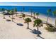 Scenic beach featuring clear water, palm trees, and a distant pavilion at 800 Chesapeake Dr # 23, Tarpon Springs, FL 34689