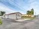 Charming single-story home with a white exterior, an awning, and well-maintained landscaping at 800 Chesapeake Dr # 23, Tarpon Springs, FL 34689