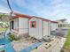 Charming home exterior with a small storage shed and a well-maintained lawn at 800 Chesapeake Dr # 23, Tarpon Springs, FL 34689