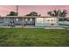 Charming home featuring a sunroom, open patio, and lush lawn near the waterfront, perfect for relaxation at 800 Chesapeake Dr # 23, Tarpon Springs, FL 34689