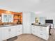 Open concept kitchen with white cabinetry, stainless steel sink, and wood countertop at 800 Chesapeake Dr # 23, Tarpon Springs, FL 34689