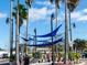 Outdoor seating area with shade sails strung between palm trees and views of the city at 800 Chesapeake Dr # 23, Tarpon Springs, FL 34689