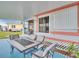 Inviting covered patio featuring an outdoor dining set and a view of the backyard at 800 Chesapeake Dr # 23, Tarpon Springs, FL 34689
