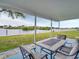 Cozy outdoor patio with a dining table and seating, offering serene waterfront views for relaxed entertaining at 800 Chesapeake Dr # 23, Tarpon Springs, FL 34689