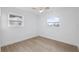 Bright bedroom with neutral walls, fan and two windows providing natural light at 8256 Lark St, Seminole, FL 33777