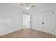 Bright bedroom featuring wood floor, neutral walls, fan and closet at 8256 Lark St, Seminole, FL 33777