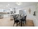 Open dining area next to the kitchen with modern table set, lighting, and sliding doors at 8256 Lark St, Seminole, FL 33777