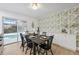 Dining room with seating for six, stylish wallpaper, and sliding door to pool at 8256 Lark St, Seminole, FL 33777