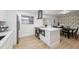 Bright kitchen featuring modern appliances, a large island, and an adjacent dining area at 8256 Lark St, Seminole, FL 33777