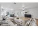 Spacious living area with a comfortable seating arrangement and an open view to the dining and kitchen areas at 8256 Lark St, Seminole, FL 33777