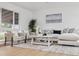 Inviting living room featuring a plush sofa, stylish decor, and a large window at 8256 Lark St, Seminole, FL 33777